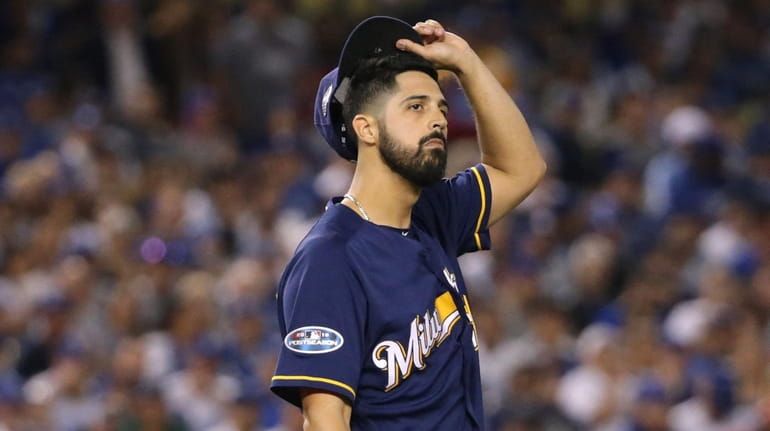 Pitcher Gio Gonzalez reacts during the second inning of Game...