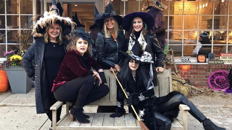 Employees of Lucky to Live Here Realty dress as witches...
