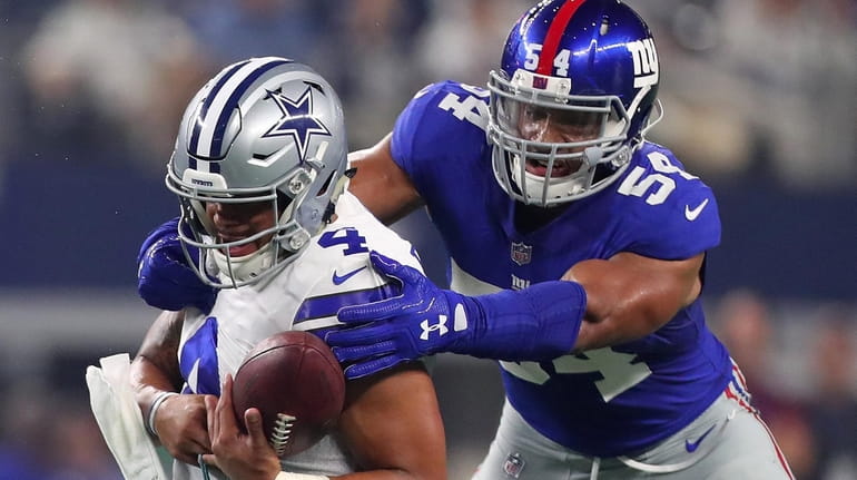 Dak Prescott of the Dallas Cowboys is sacked by Olivier...