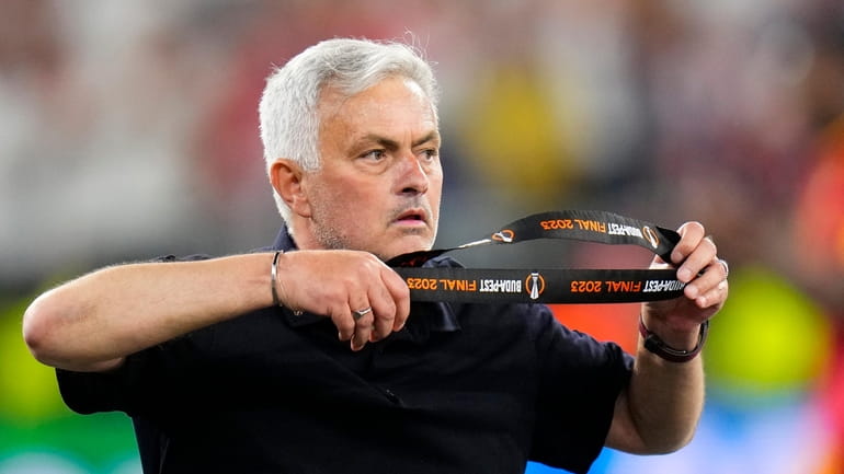 Roma's head coach Jose Mourinho takes off his second place...