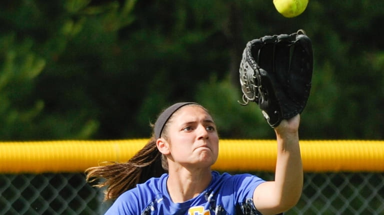 East Meadow's Julianna Sanzone catches a fly ball in leftfield...