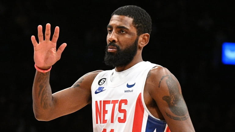 Nets guard Kyrie Irving gestures in the first half of...