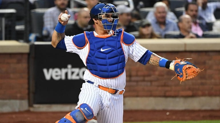 New York Mets catcher Wilson Ramos throws the ball to...
