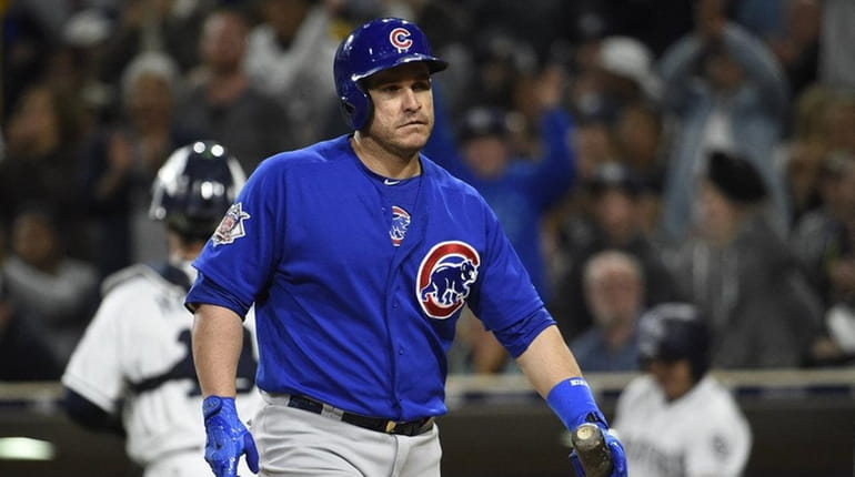 Miguel Montero #47 of the Chicago Cubs walks back to...