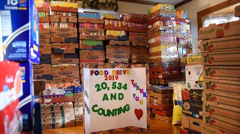 Donated food items are stacked high inside the Lynbrook home...