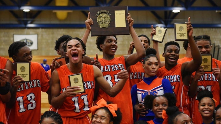 Malverne's Gray Dorleans, second from left, and Donovan Ishmael, holding...