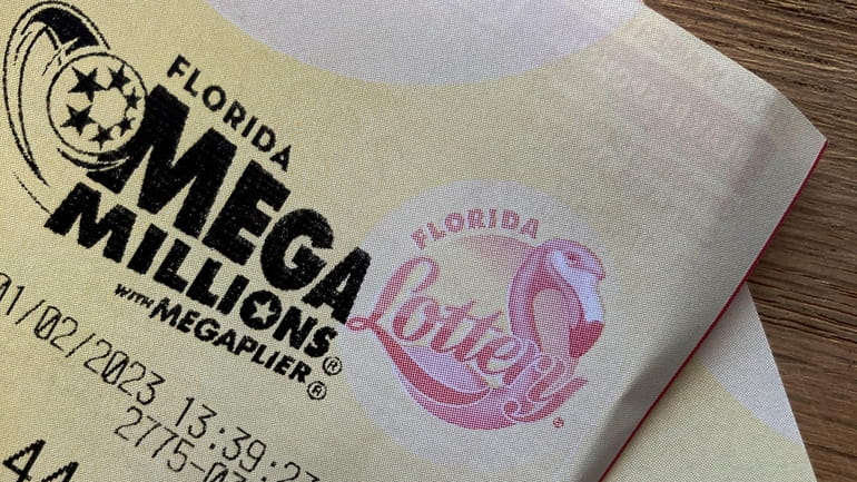 A Mega Millions lottery ticket is shown Monday in Surfside, Florida.