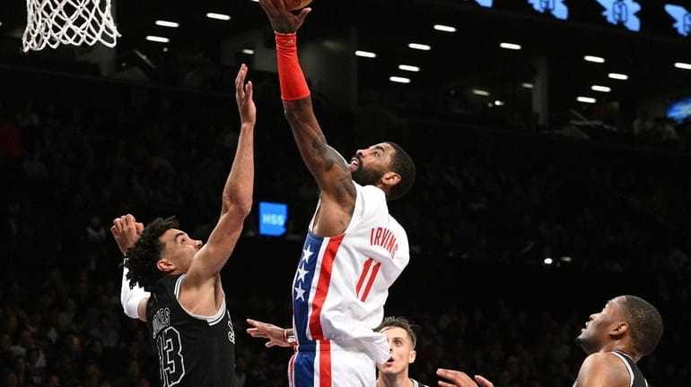 Brooklyn Nets guard Kyrie Irving puts up a layup against...