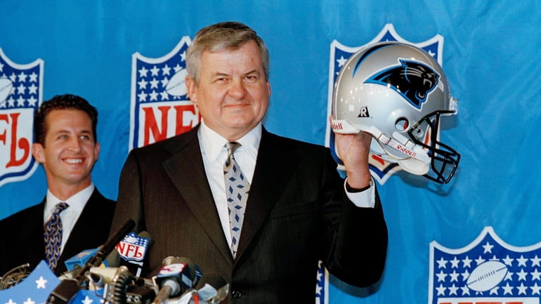 Jerry Richardson shows off his new team's helmet as the...