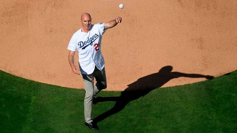 Former Dodgers outfielder Kirk Gibson throws the ceremonial first pitch...