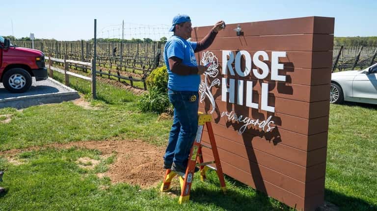 In Mattituck, workers put the finishing touches on the newly renamed...