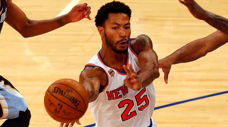 Derrick Rose of the New York Knicks dishes off a...