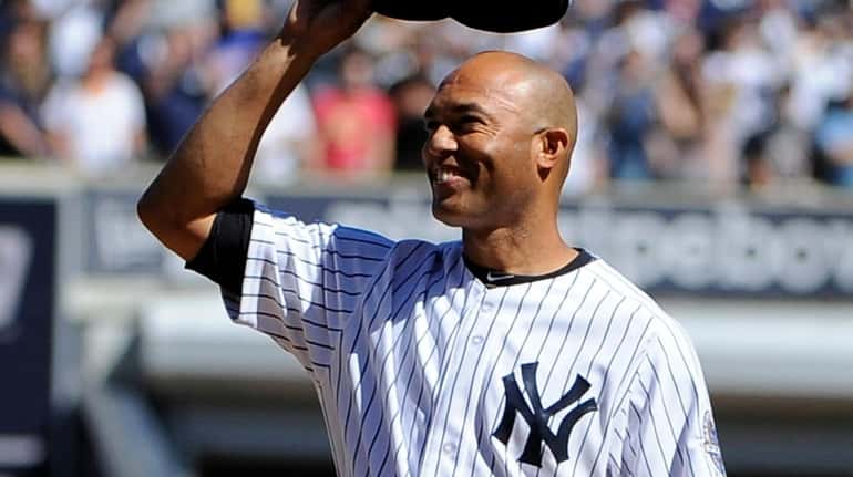 New York Yankees pitcher Mariano Rivera raises his cap during...