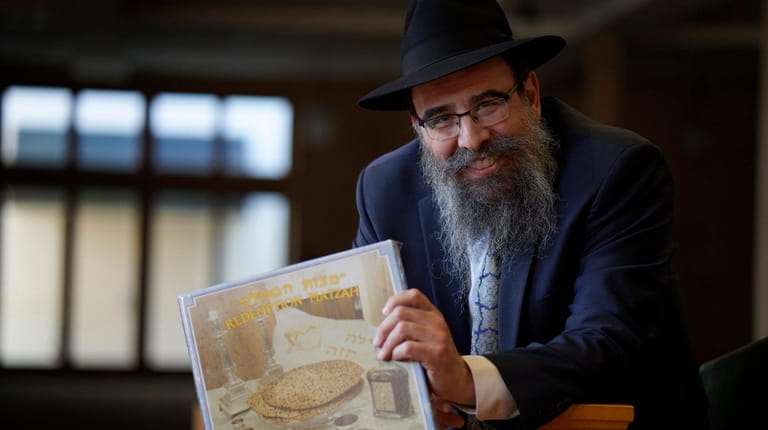 Rabbi Shalom Paltiel, shown at Chabad of Port Washington, holds...