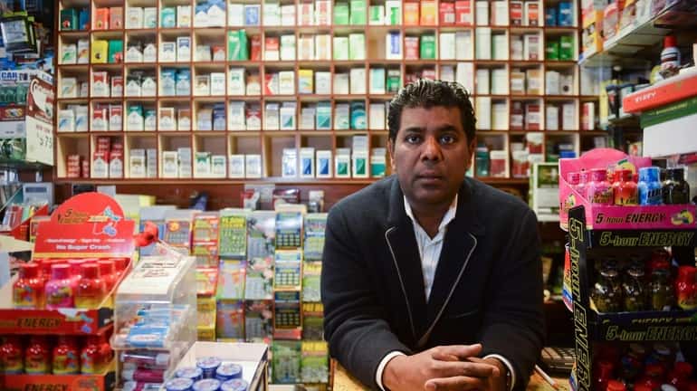 Tarik Ahmed, owner of Locust Valley Tobacco, stands inside his...