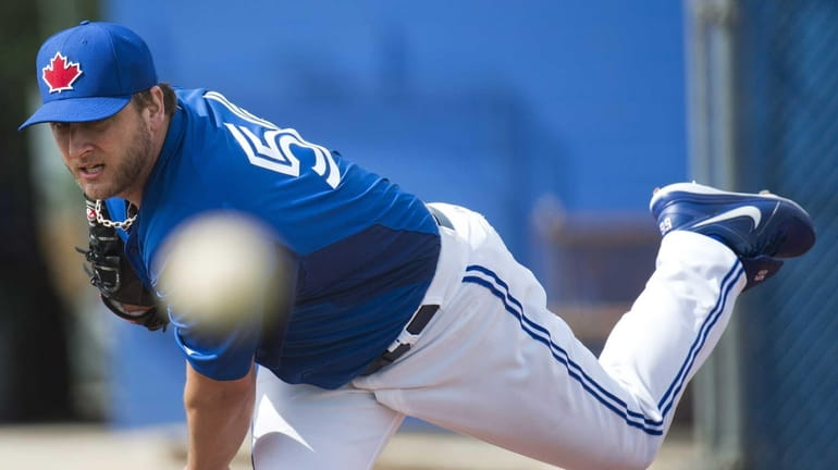 Toronto Blue Jays starting pitcher Mark Buehrle throws in the...