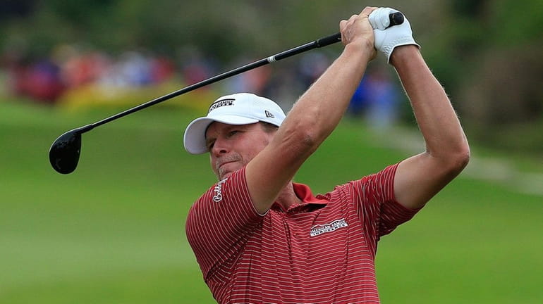 Steve Stricker hits his second shot on the third hole...