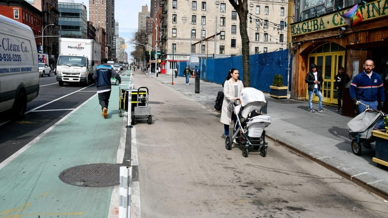 Pedestrians and delivery people traverse the new "super sidewalks" on...