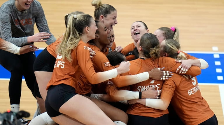 Texas players celebrate after winning the NCAA Division I women's...