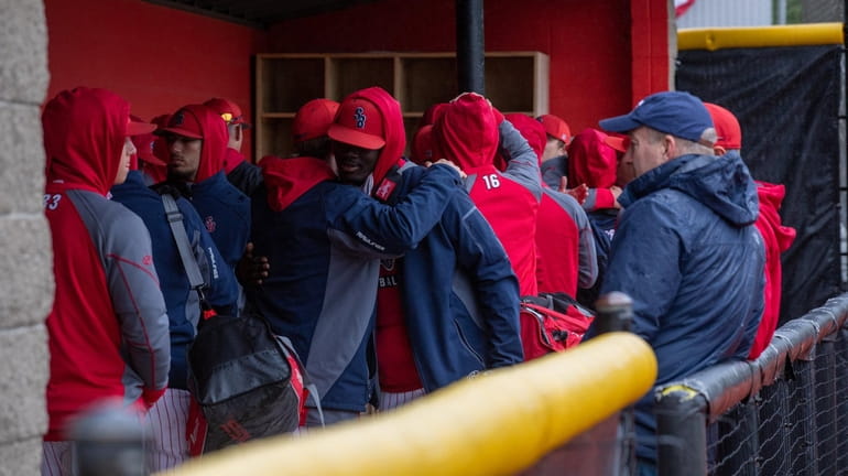 Stony Brook baseball players hug after receiving announcement that the...