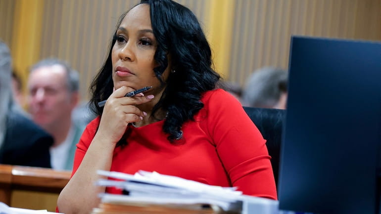 Fulton County District Attorney Fani Willis looks on during a...