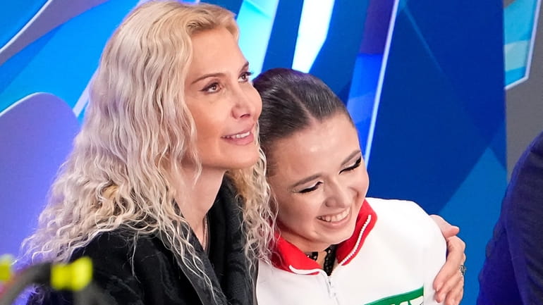 Russian Kamila Valieva, right, and her coach Eteri Tutberidze react...