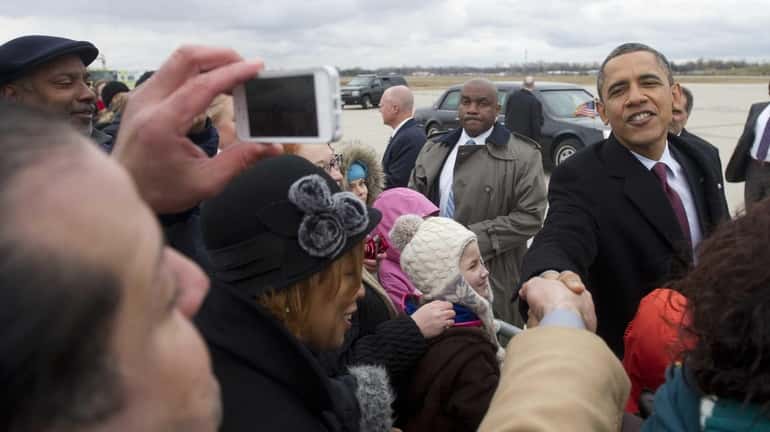 President Barack Obama greets well-wishers after arriving on Air Force...
