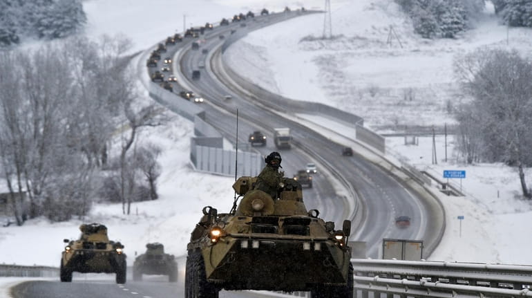 Russian armored vehicles move along a highway in Crimea on  Jan....