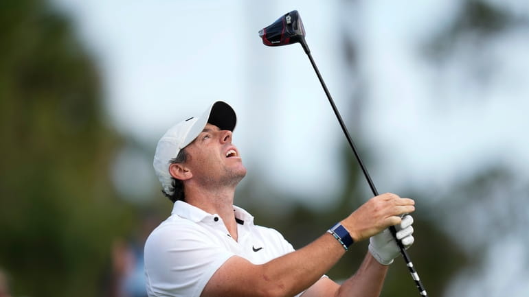 Rory McIlroy, of Northern Ireland, reacts after his tee shot...