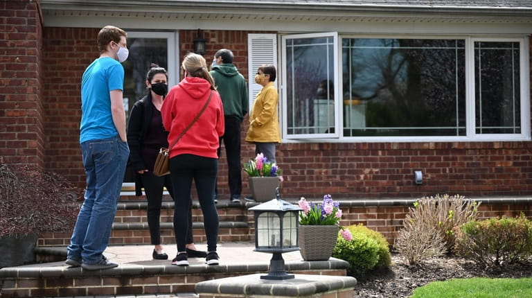 Prospective buyers line up outside an open house in Westbury...