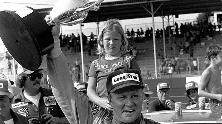 Cale Yarborough of Timmonsville S.C., holds his trophy high in...