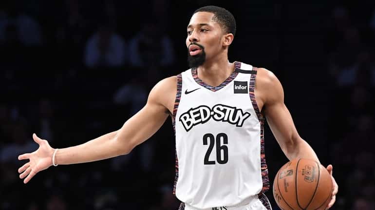 Nets guard Spencer Dinwiddie dribbles the ball up court against...