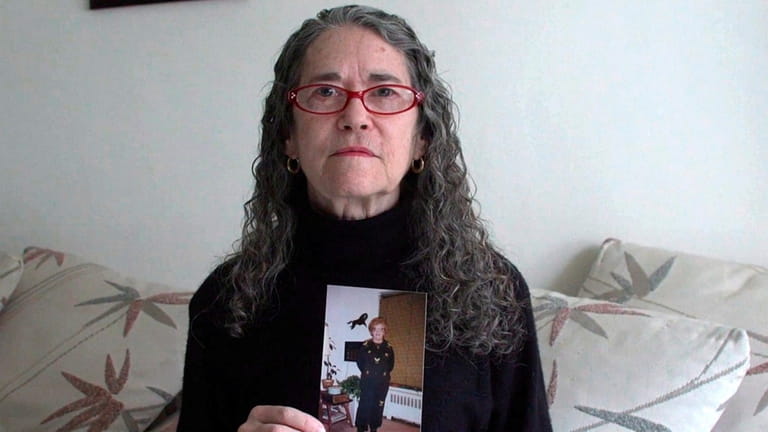 Nancy Gertler, of Great Neck, holds a photograph of her...