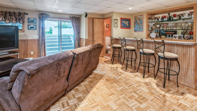 The lower-level entertainment room with wet bar.