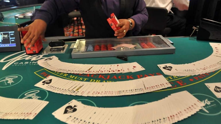 A blackjack dealer works on the Escapade, a luxury gambling...