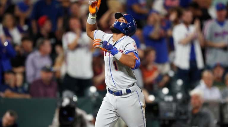New York Mets' Amed Rosario gestures as he circles the...