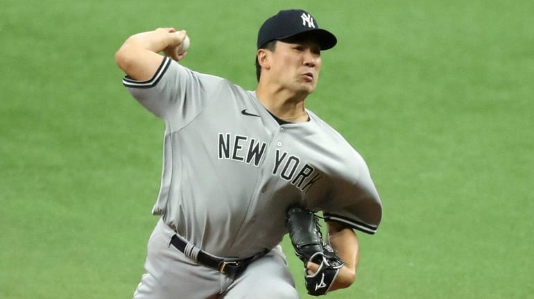 Masahiro Tanaka of the Yankees throws against the  Rays in the...