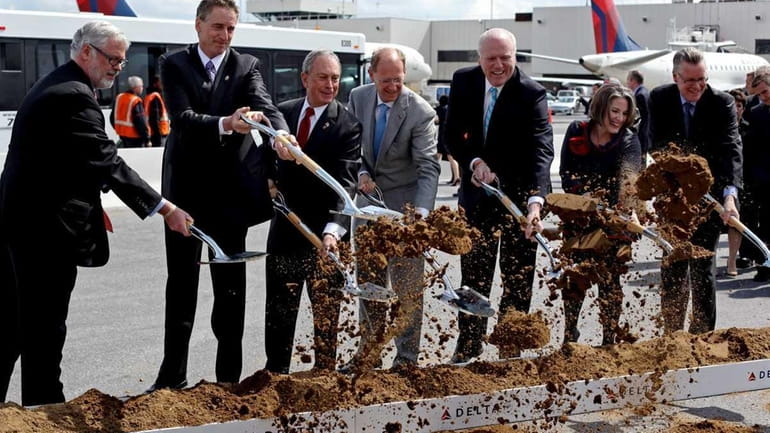 Officials turn shovels of dirt Wednesday to help Delta Airlines...