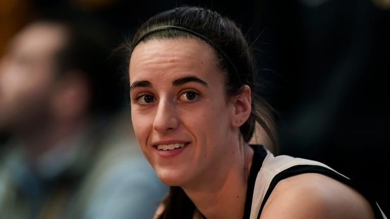 FILE - Iowa guard Caitlin Clark sits on the bench...