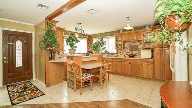 The house has an updated kitchen, including custom maple cabinets.