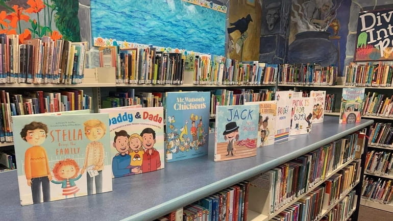 Pride Month books on display in the children's section in a branch of...