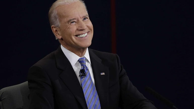 Vice President Joe Biden smiles after hearing a question during...
