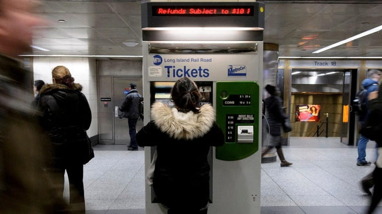 Long Island Rail Road passengers purchase tickets at Penn Station...