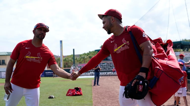 St. Louis Cardinals manager Oliver Marmol, left, shakes hands with...