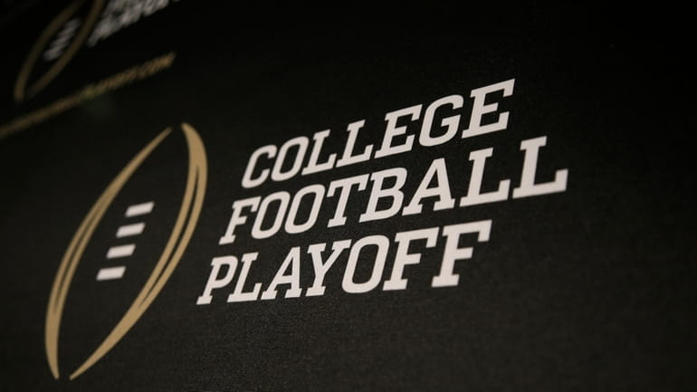 The College Football Playoff logo is printed across a backdrop...