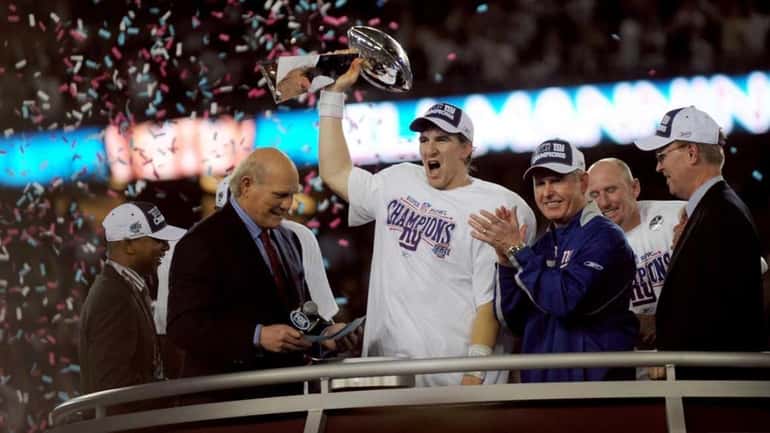 Giants quarterback and Super Bowl MVP Eli Manning holds the...