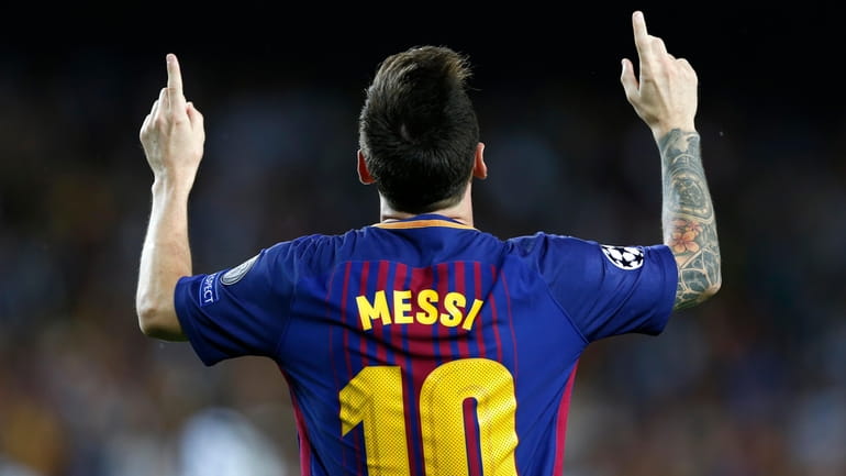 Barcelona's Lionel Messi celebrates after scoring his side's first goal...
