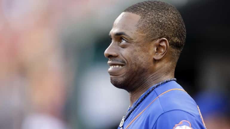 New York Mets' Curtis Granderson reacts in the dugout after...