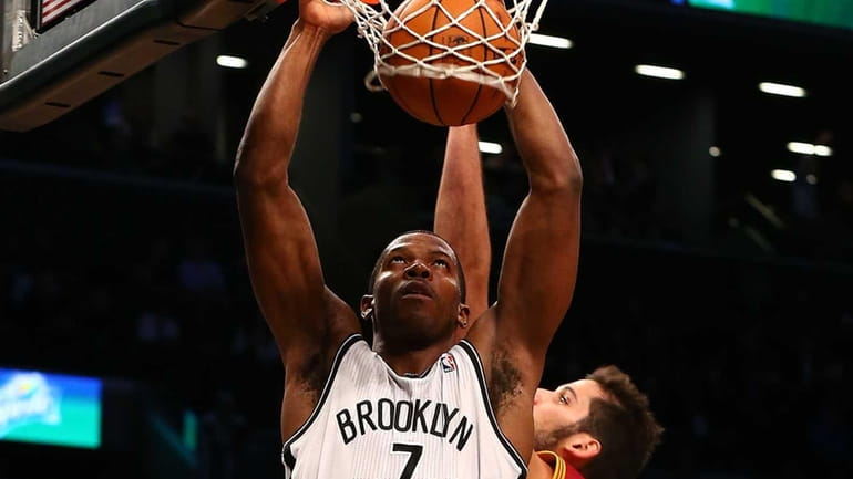 Joe Johnson dunks the ball in front of the Cleveland...