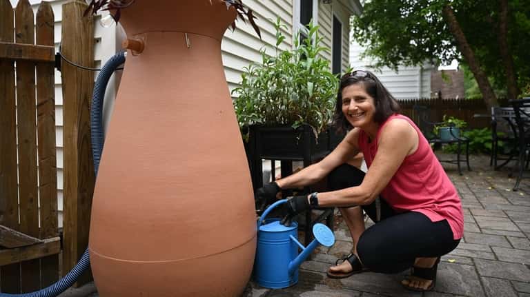 Joanne Strongin uses a 65-gallon rain barrel to save water...